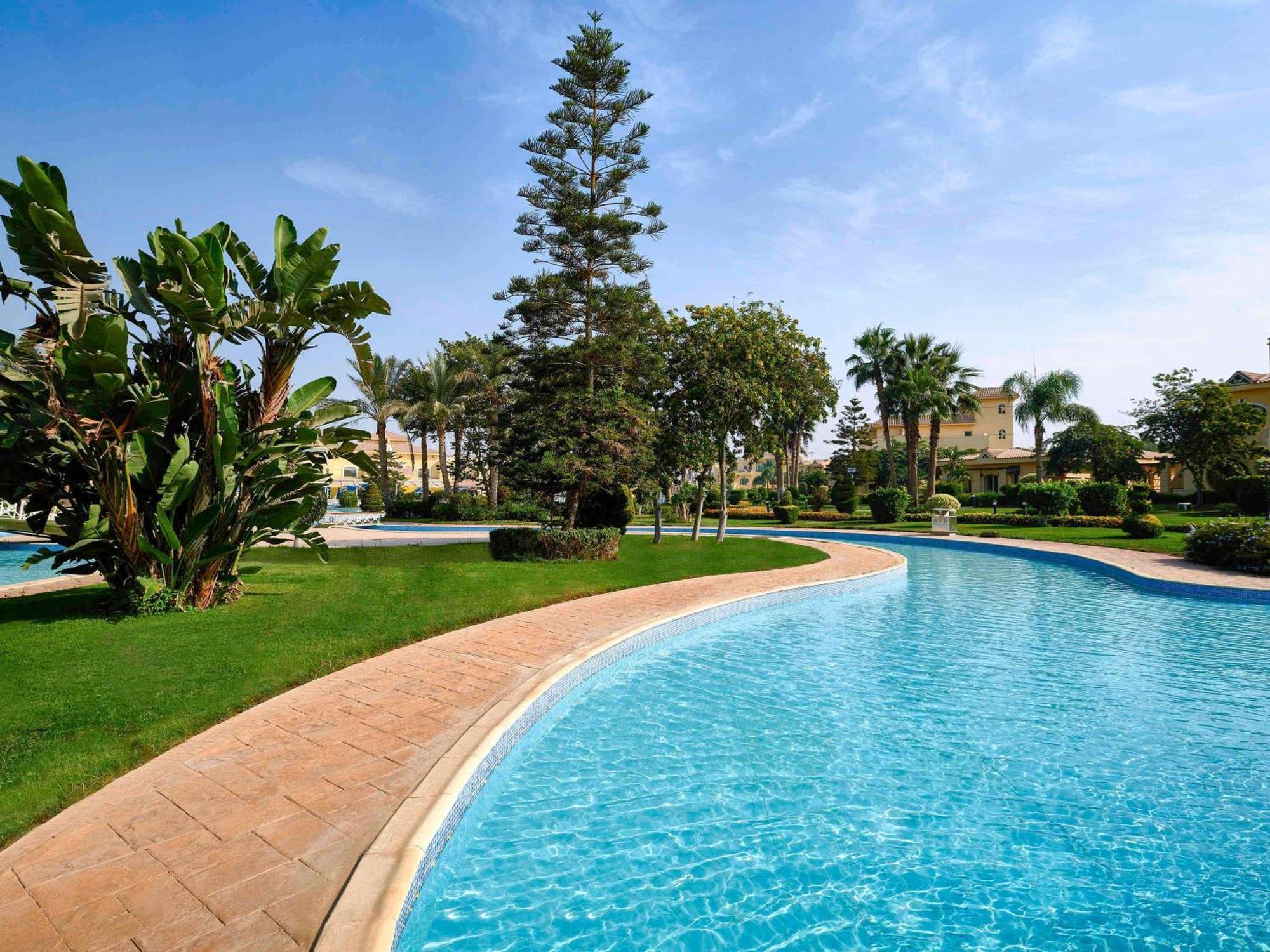 Moevenpick Hotel Cairo - Media City Giza Exterior photo A swimming pool in a resort